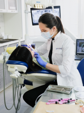 A dentist consulting with a patient, emphasizing the importance of dental marketing.